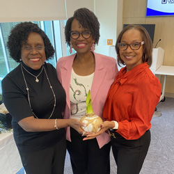 Three Women smiling at the camera.